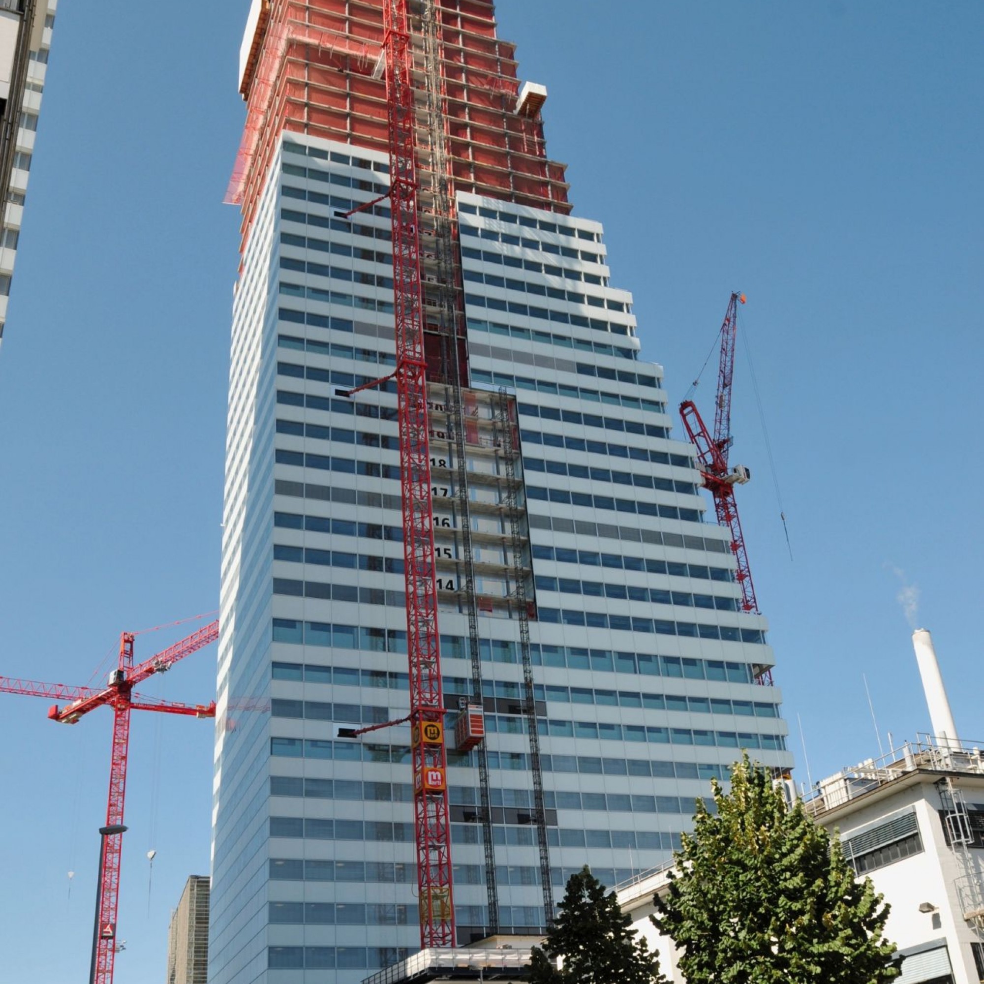 Deux ascenseurs de façade permettent aux ouvriers d'acheminer leur matériel jusqu'aux étages supérieures de la construction.
