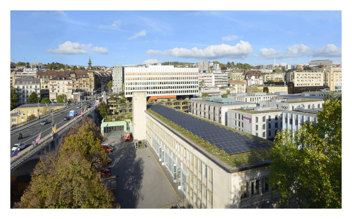 Image de synthèse représentant une toiture végétalisée et des panneaux solaires parfaitement intégrés dans le paysage.